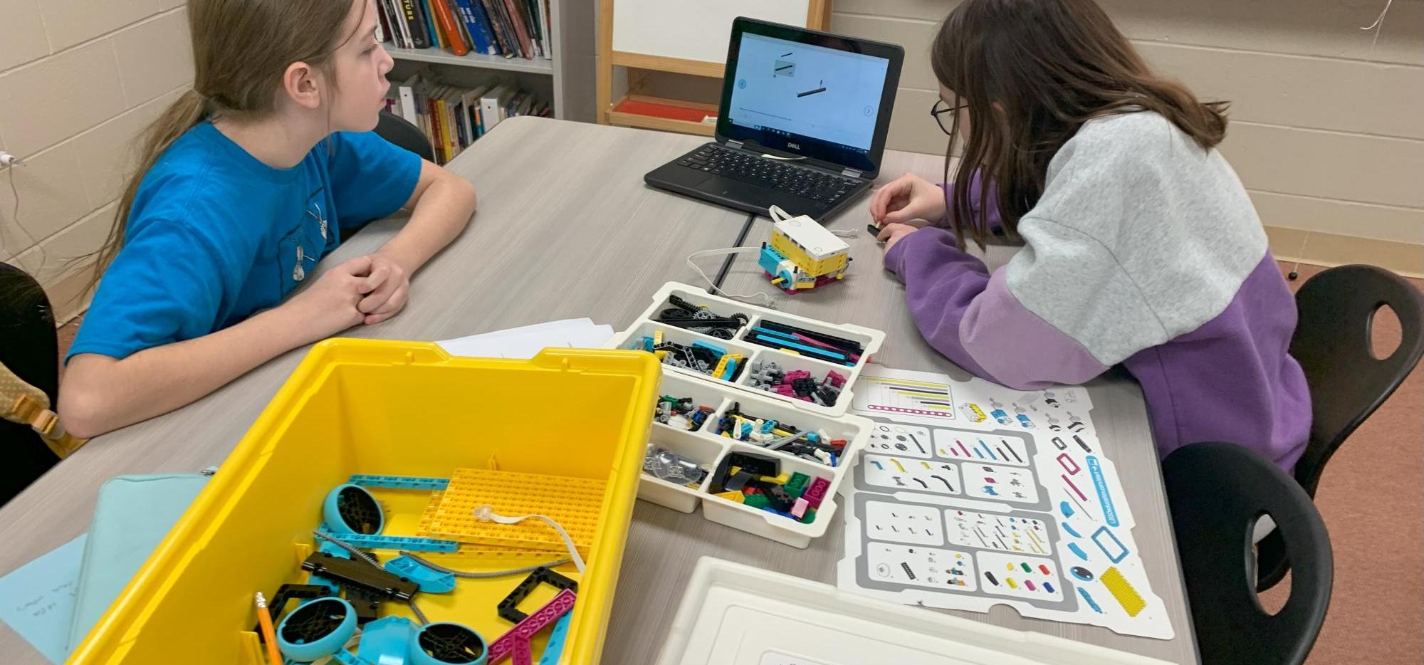 two students coding with lego robotics