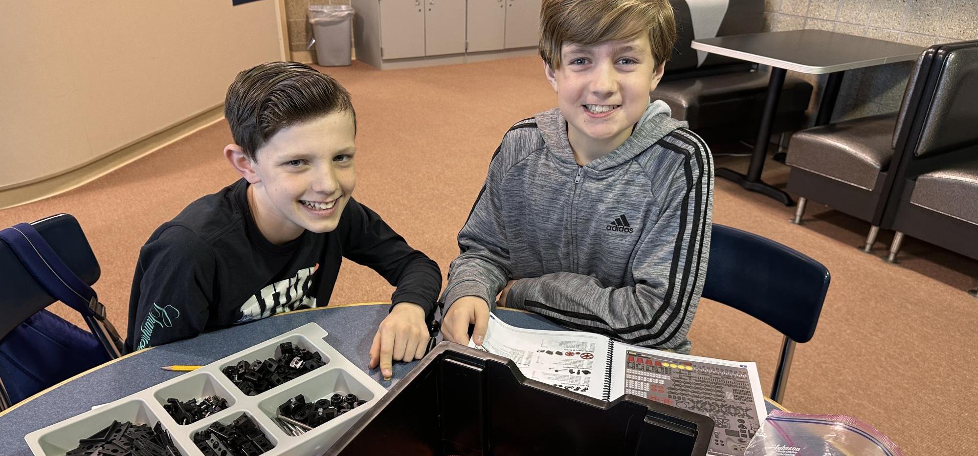 two students building tetrix robots